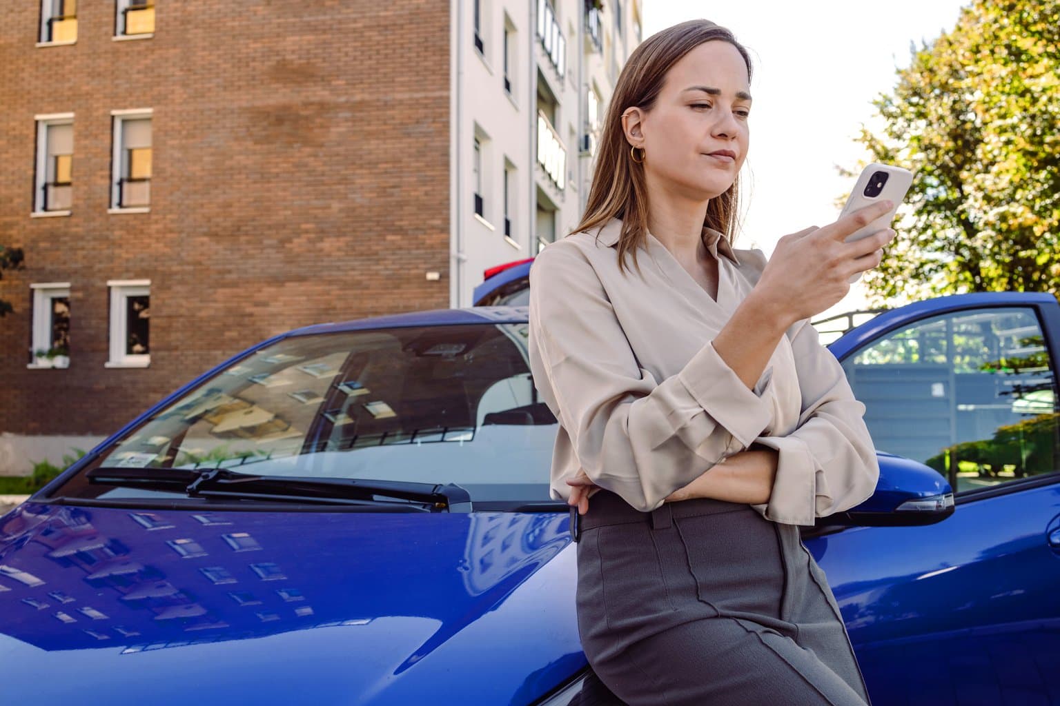 Woman leaning on car