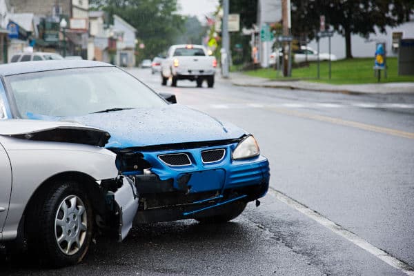 An image of a white car that collided with a blue car on the road