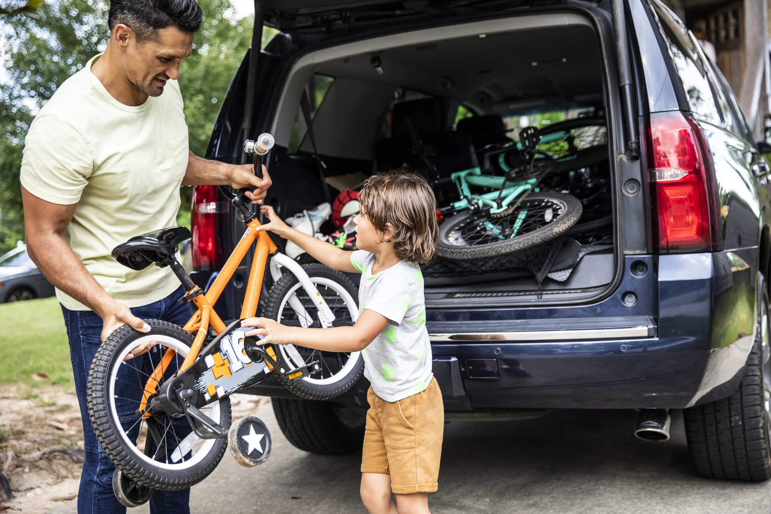Person unloading bike from car.